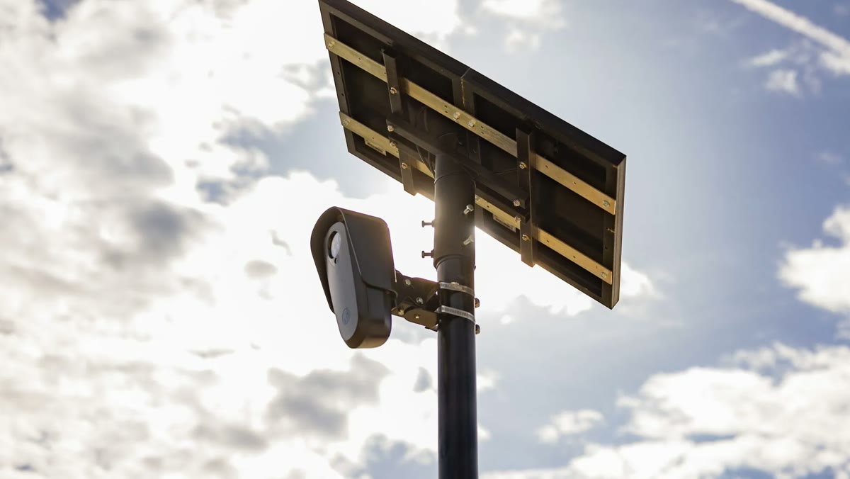 A Flock Safety license plate camera and its solar panel on a pole