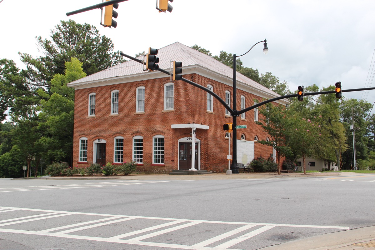 The Broadwell Building, a two-story red-brick commercial structure at the Crabapple five-way crossroads in Milton, Georgia. Built circa 1900 by John Broadwell, still in active use today.
