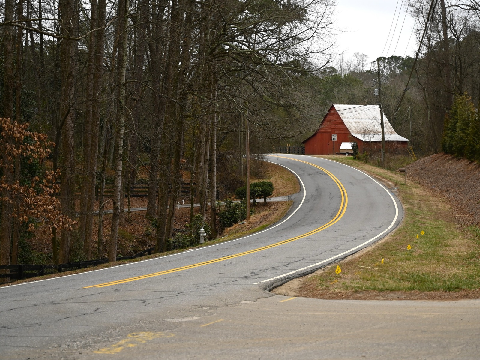 Winding road past a red barn in Milton